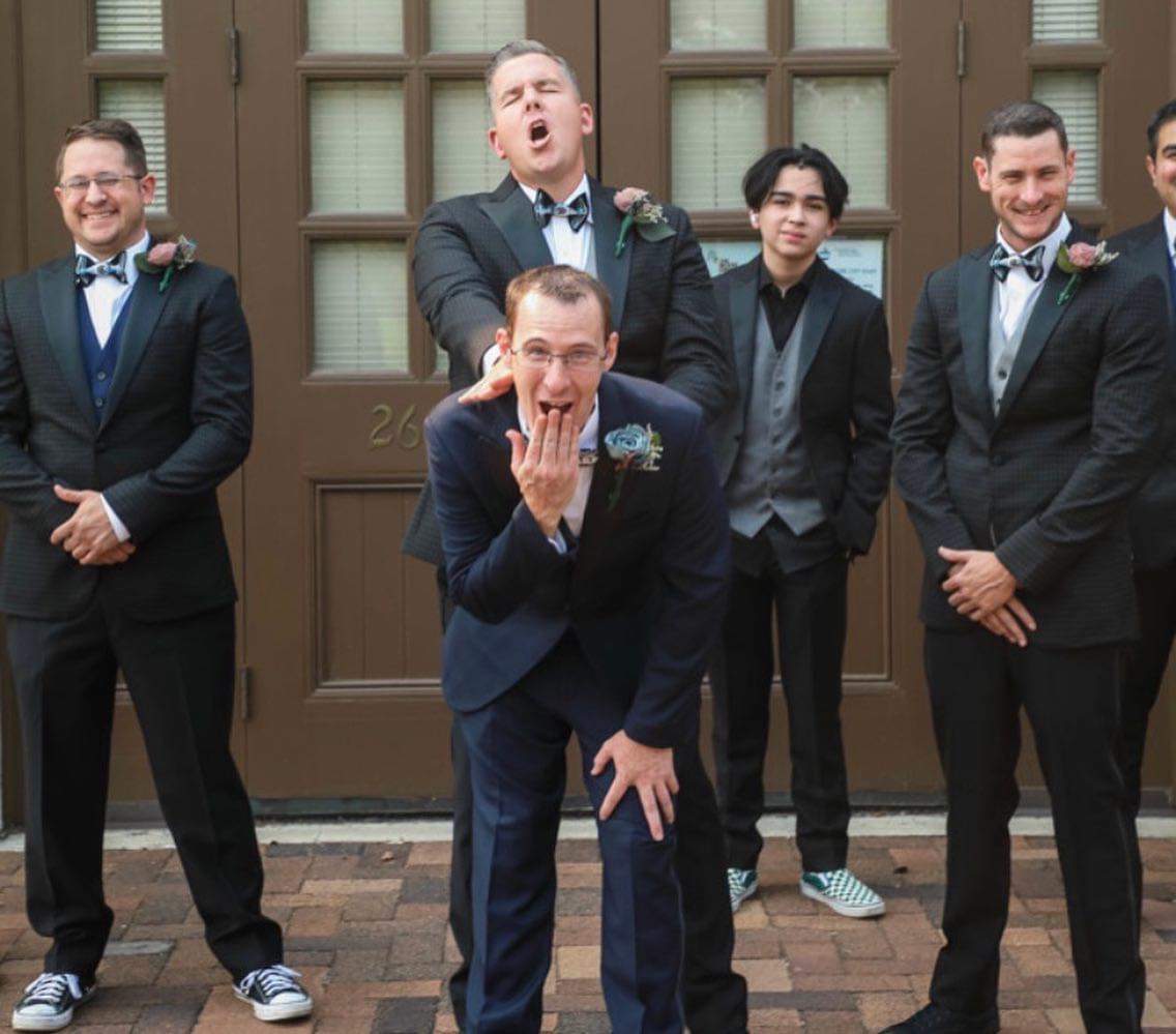 A humorous wedding group photo featuring Todd and Jurgy